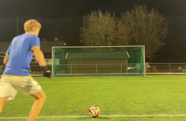 Filmed from behind the shooter: the player, the ball and the whole goal in the picture